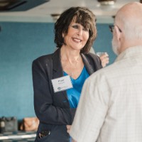 President Mantella smiling during conversation with older gentleman